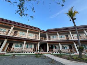 an image of the front of a hotel with a palm tree at Leego Hotel in Luang Prabang