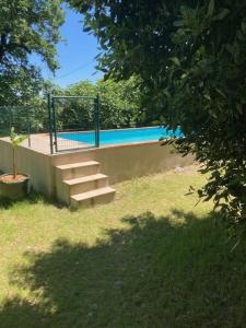 a set of stairs next to a swimming pool at Bastide Armande in Dénat