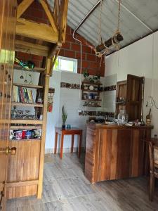 a kitchen with a counter and a table in a room at Cabane Finca la Gloria in San Vicente de Chucurí