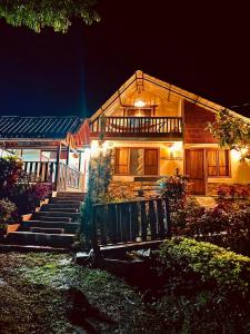 a house with stairs leading up to it at night at Cabane Finca la Gloria in San Vicente de Chucurí