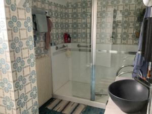 a bathroom with a shower with a tub and a sink at Chez l habitant in Méré
