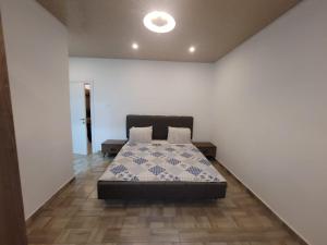 a bedroom with a bed in a white room at Bamboo Beach Resorts in Paynesville
