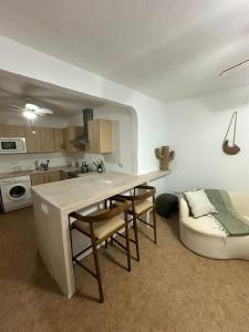 a kitchen with a table and chairs and a couch at Cortijo Chupito in Yunquera