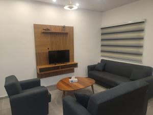 a living room with two couches and a television at Bamboo Beach Resorts in Paynesville