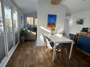 a kitchen and dining room with a white table and chairs at Ferienhaus Feldblick in Fehmarn