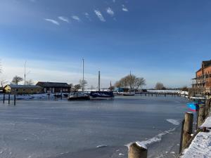 a frozen lake with boats sitting on it at Ferienhaus Feldblick in Fehmarn