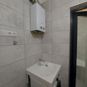 a bathroom with a white sink and a mirror at Центр,дитяче містечко Казка in Mykolaiv