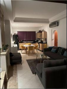 a living room with a couch and a table at VILLA DETENTE PISCINE PRIVEE PROCHE D'AGADlR in Taroudant