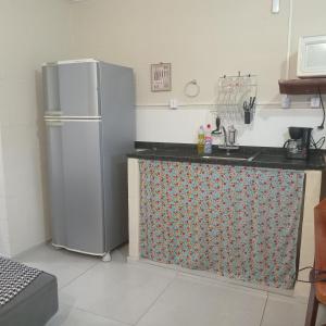 a kitchen with a stainless steel refrigerator in a room at Loft Caminho de Búzios in Cabo Frio