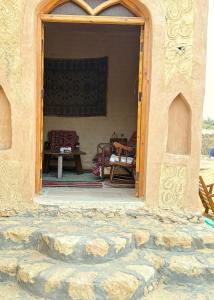 an open door to a patio with a table at Bandres farm in Siwa