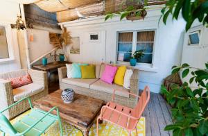 a patio with a couch and a table and chairs at Schuhmacherei Rooms in Oestrich-Winkel