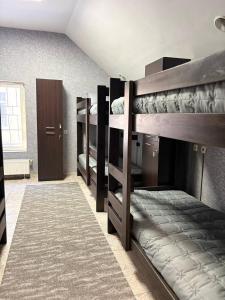 a room with three bunk beds in a room at Хостел Гора in Kharkiv