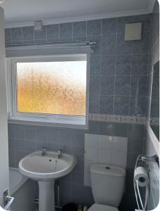a bathroom with a sink and a toilet and a window at Sea Rose ,Broadstairs in Broadstairs +34 photos