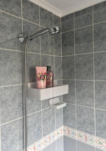 a shower with a shower head in a bathroom at Sea Rose ,Broadstairs in Broadstairs