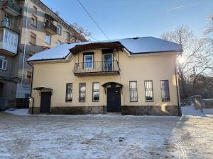 a building with a balcony on the front of it at Хостел Гора in Kharkiv