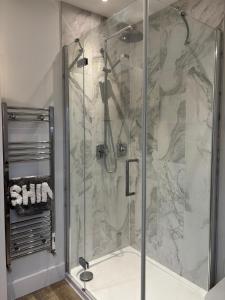 a shower with a glass door in a bathroom at Tollgate Annexe in Ashford +39 photos