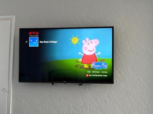 a flat screen tv hanging on a wall at Sea Rose ,Broadstairs in Broadstairs