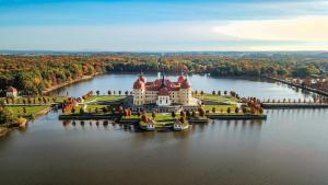 an island with a castle in the middle of a lake at Design Studio Altstadt nahe Malerweg in Pirna