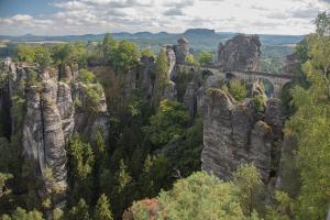a view of a mountain with a bridge and trees at Design Studio Altstadt nahe Malerweg in Pirna +8 photos