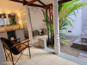 a living room with a fireplace and a mirror at WG Villa Wathurugama in Kannimahara