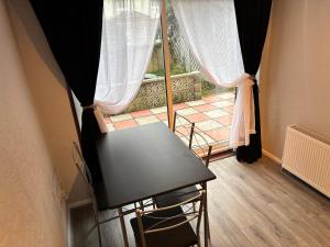 a table and chairs in a room with a window at Sea Rose ,Broadstairs in Broadstairs