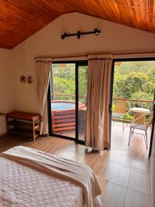 a bedroom with a bed and a sliding glass door at Cabañas Alondra - Hotel Boutique in Vergara +41 photos