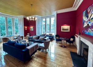 a living room filled with furniture and a fireplace at Birchwood Pitlochry in Pitlochry