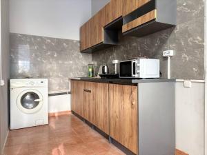 a kitchen with a washing machine and a washer at Хостел Гора in Kharkiv