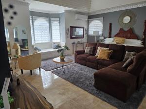 a living room with a couch and a bed at Dr Doc's Family Lodge with Pool in Spur Tree
