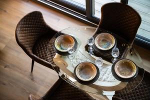 a table with cups and wine glasses on it at Vencello Estelar Compostela in Santiago de Compostela