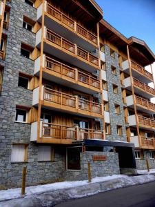 an apartment building with balconies on the side of it at Ambiance Chalet in Tignes