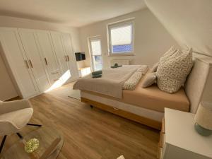 a bedroom with a large bed and a window at Ferienhaus Sonnenblick Wernigerode in Wernigerode