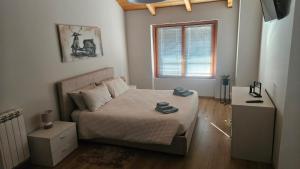 a small bedroom with a bed and a window at FredaLuna in Tirano