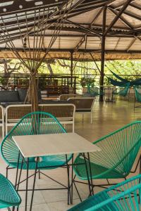 a table and chairs in a restaurant with a table at The Cantamar Beach Hostel in Santa Marta +75 photos