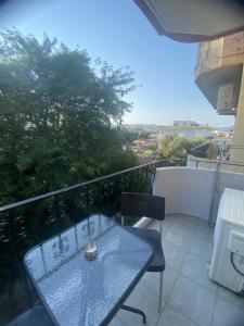 a table and chairs on a balcony with a view at Dimi's home in Komotini