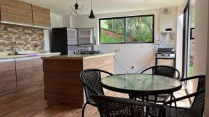a kitchen with a table and chairs in a kitchen at Finca Hotel Mariangel in El Peñol