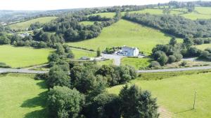 an aerial view of a house in the middle of a field at The Serendipity Suite - A Scenic Countryside Hideaway in Letterkenny