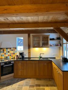 a kitchen with wooden cabinets and a black counter top at Speicher in Soltau in Soltau
