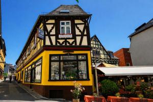 a yellow and black building on a street at Haus der Weine in Rüdesheim am Rhein
