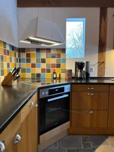 a kitchen with a black stove top oven at Speicher in Soltau in Soltau +2 photos