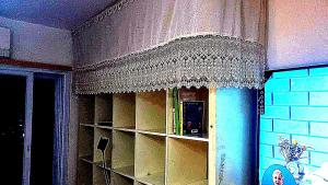 a curtain over a book shelf in a room at Big Room Ashdod in Ashdod