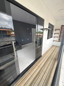 a glass house with a view of a balcony at Casa disponível para o carnaval in Belém