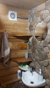 a bathroom with a sink and a stone wall at У Медовому Раю in Rostoka +142 photos
