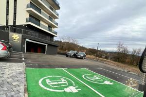 a parking lot with cars parked in front of a building at ARIA Luxury Apartment, Tuzla in Tuzla
