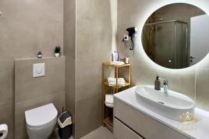 a bathroom with a sink and a mirror at ARIA Luxury Apartment, Tuzla in Tuzla