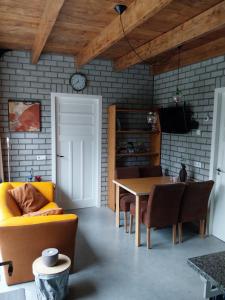 a living room with a table and a dining room at Gastenverblijf De Lopende Eend in Boxtel