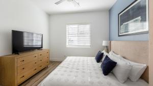 a bedroom with a bed and a flat screen tv at Landing Incredible 2BD Gym in Phoenix +32 photos