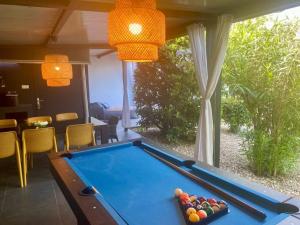 a pool table in a living room with a view at Villa CD in Dramalj