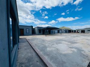 an empty parking lot with an umbrella in a building at Exodus Guesthouse Mahlakwena Stee'lpoort in Steelpoort