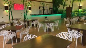 a restaurant with tables and chairs in a room at Bamboo Beach Resorts in Paynesville